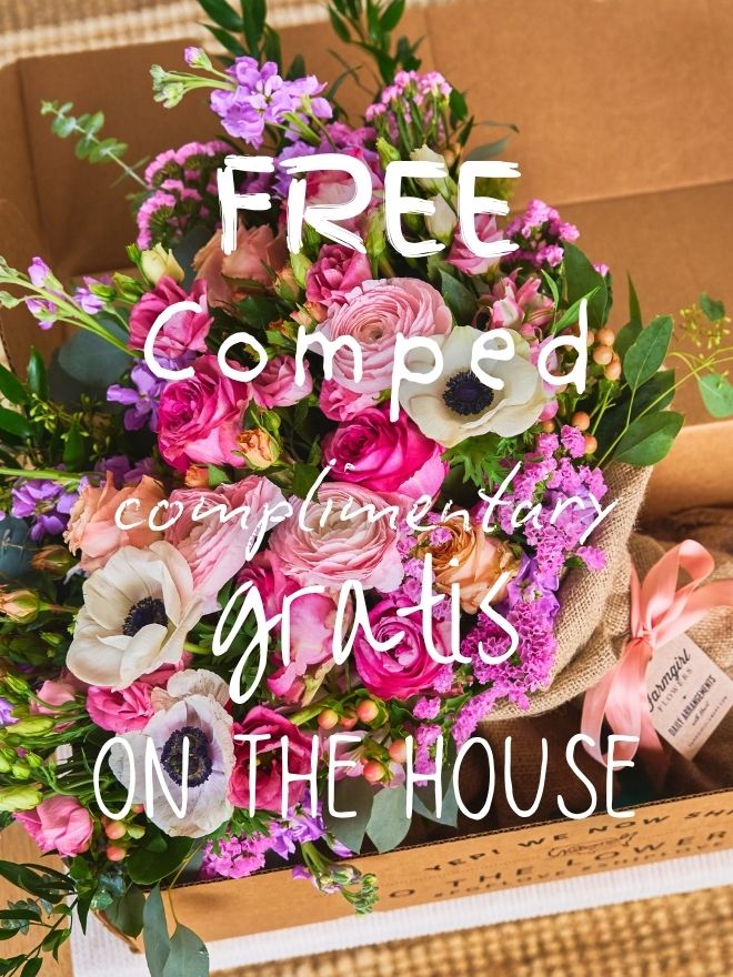 Pink and purple bouquet in a burlap-wrapped box, overlaid with 