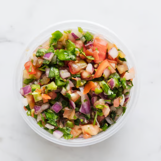 Pico de gallo salsa in a clear container, viewed from above