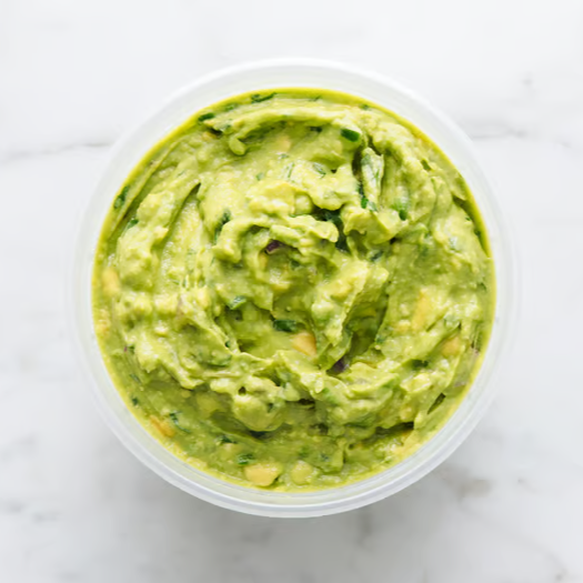 Guacamole in a clear container, viewed from above