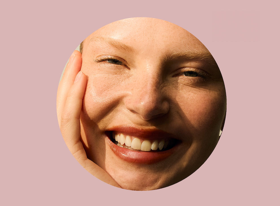 Close-up of a woman's face and a molecular structure within a pink circle.
