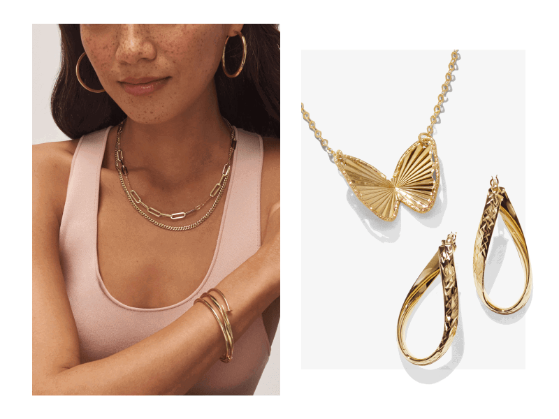 Woman wearing layered yellow gold necklaces, hoops and bracelets. Butterfly pendant necklace with teardrop hoops.