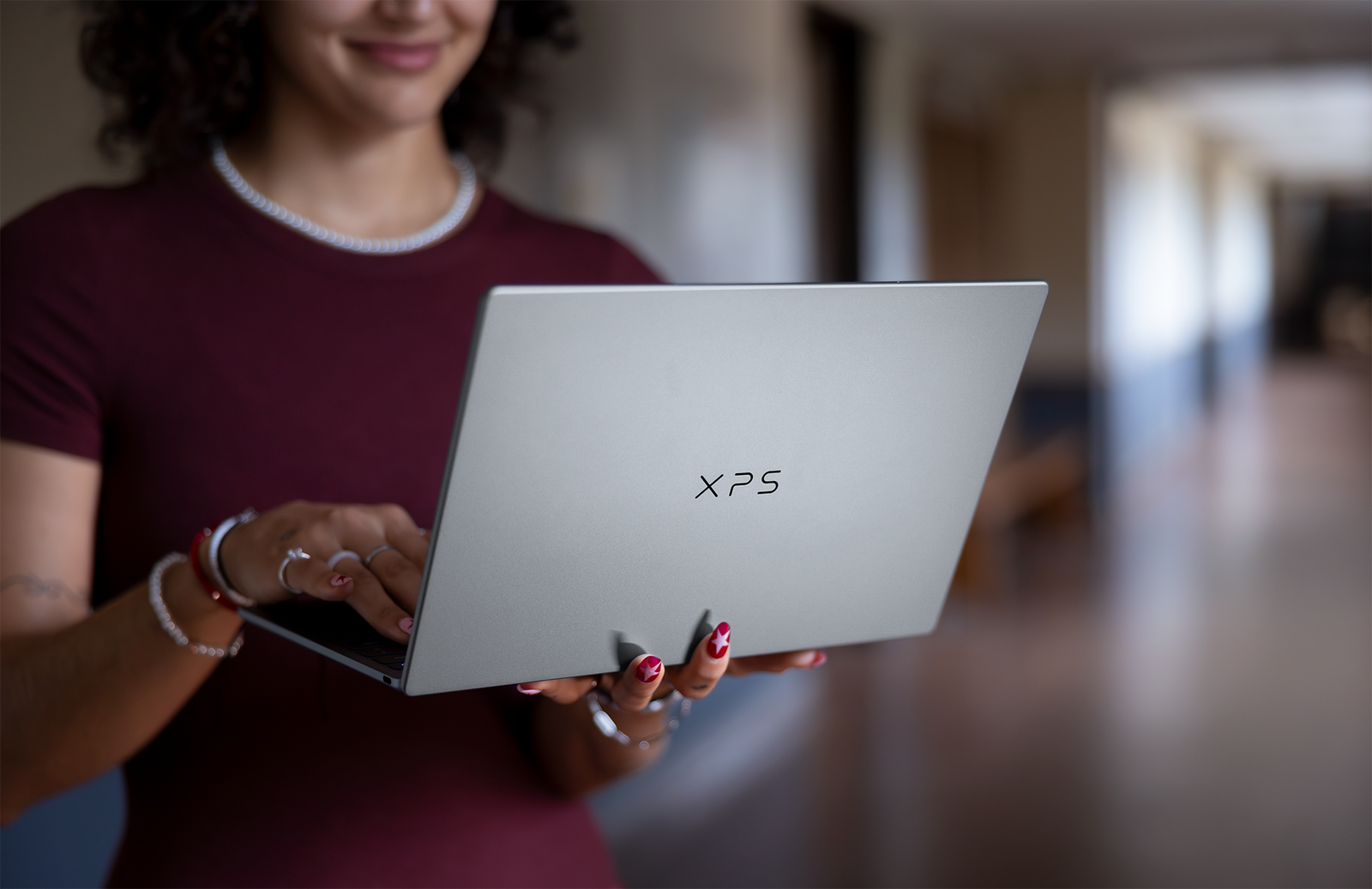 Woman sitting at table using laptop.