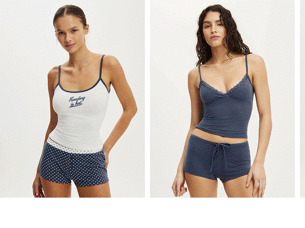 Woman wearing white camisole tank top and navy patterned shorts