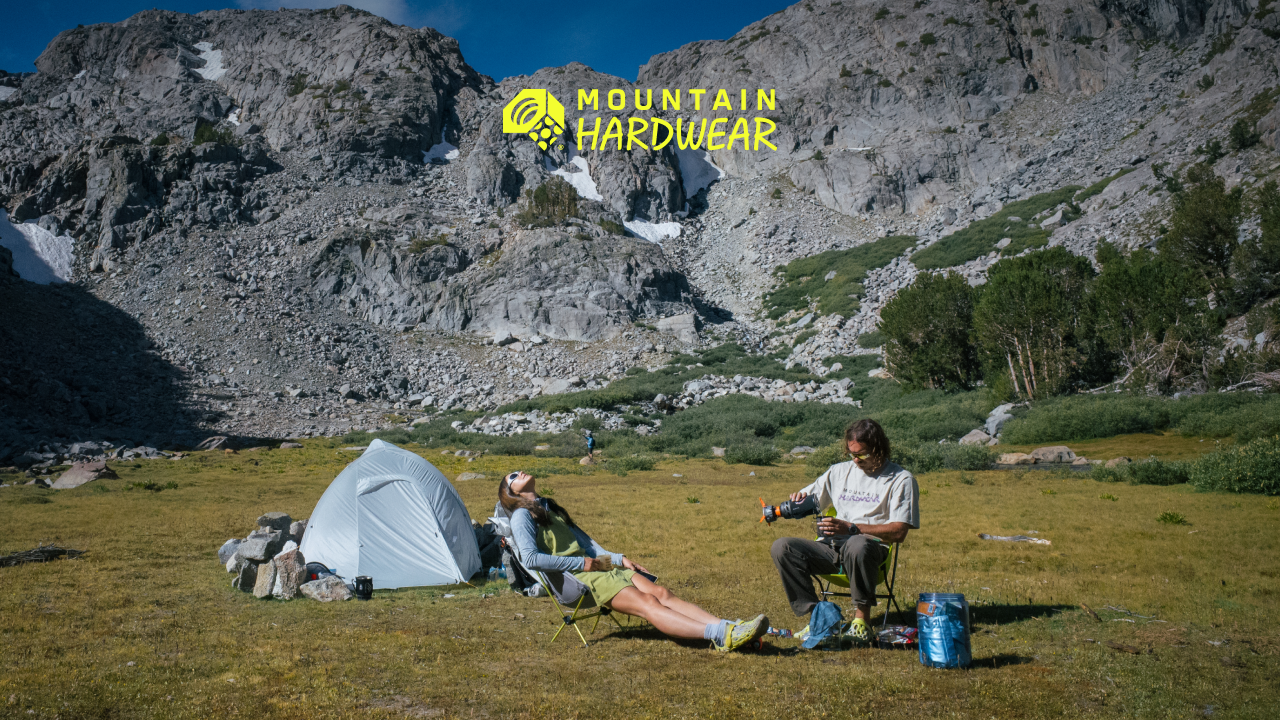 Two campers lounging at their campsite.