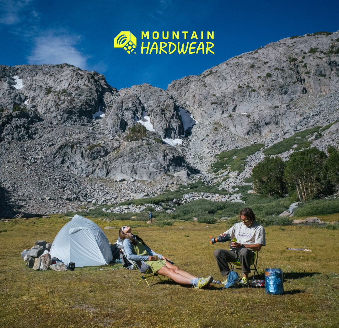 Two campers lounging at their campsite.