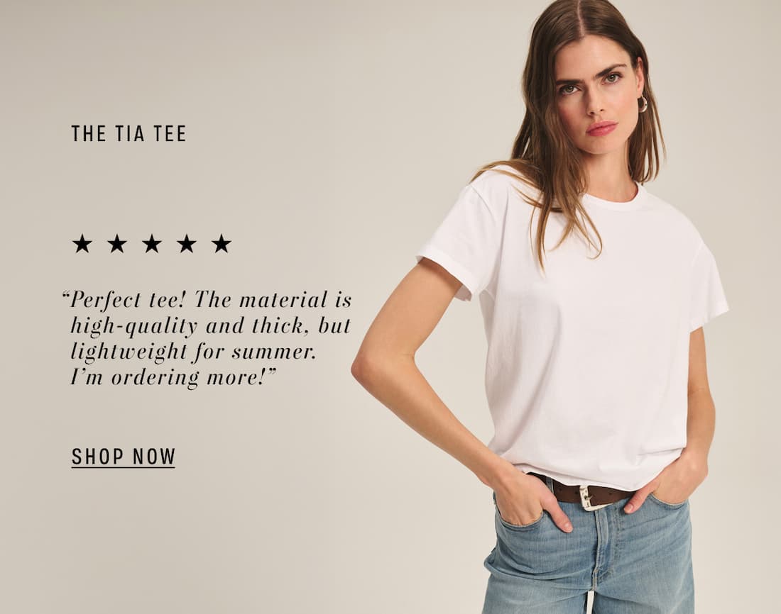 Image shows a model wearing the Tia Top in White. Text Reads: “Perfect tee! The material is high-quality and thick, but lightweight for summer. I’m ordering more!”