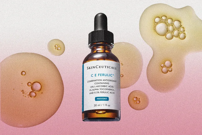 photo of skinceuticals ce ferulic bottle on pink gradient background with serum droplets