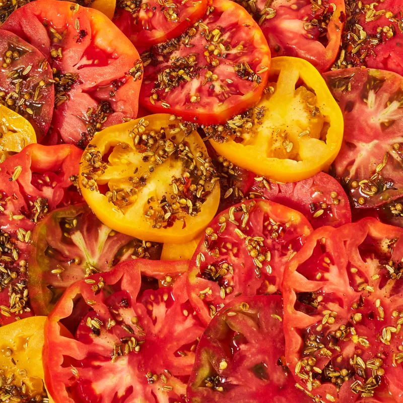 A close up of brown butter sliced tomatoes