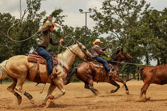 A cowboy wearing Cowman 13" Shrunken Shoulder in tan.
