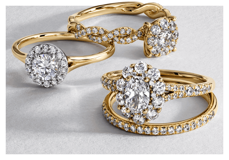 Various yellow gold diamond engagement rings and band.