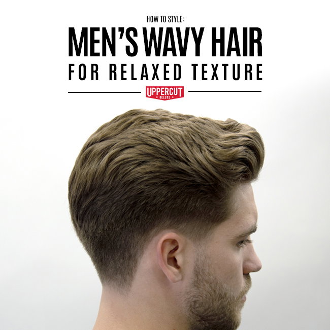Man styling his hair while looking into a mirror
