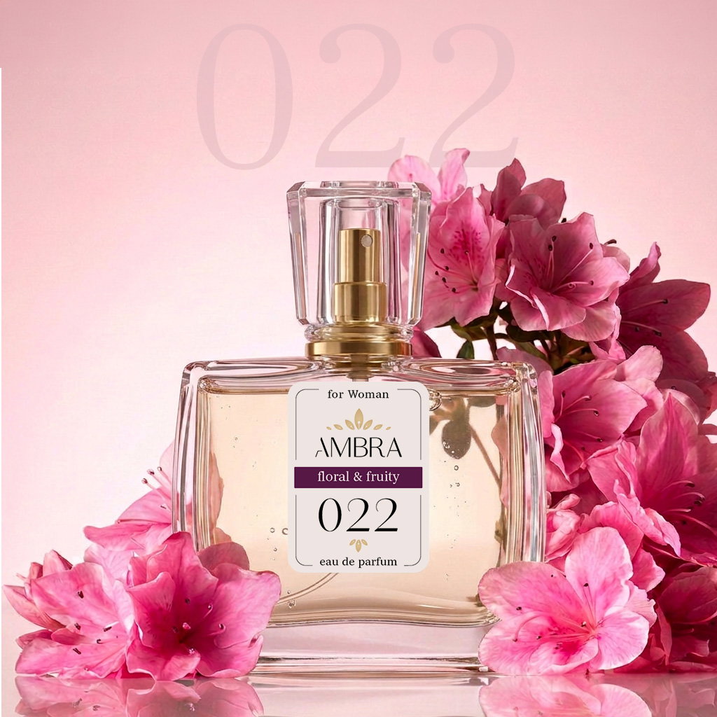 Glass bottle of Ambra 022 floral & fruity eau de parfum for women with gold spray cap, surrounded by pink azalea flowers on pale pink background