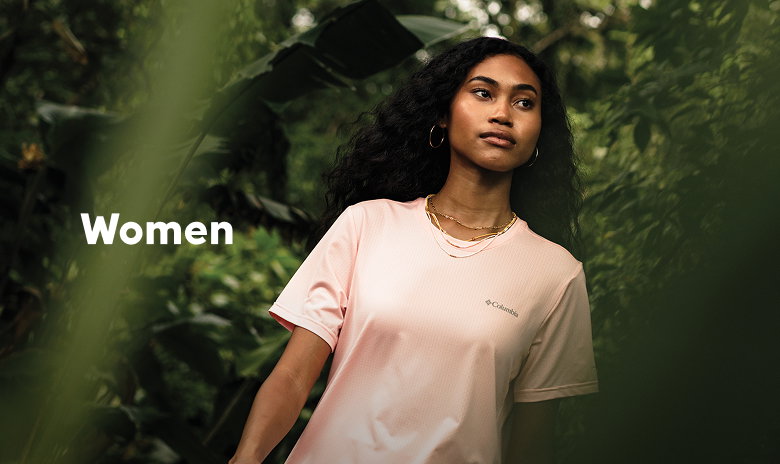 A woman wearing a pink shirt in the forest
