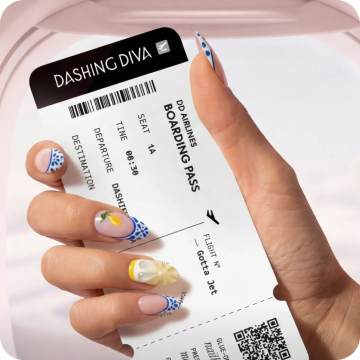 Close-up of a hand holding a Dashing Diva boarding pass-style nail art card, with nails featuring Santorini Spritz Magic Press Design