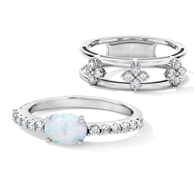 Oval opal ring with a pavé-style band paired with a white gold ring featuring marquise and round clear stones.
