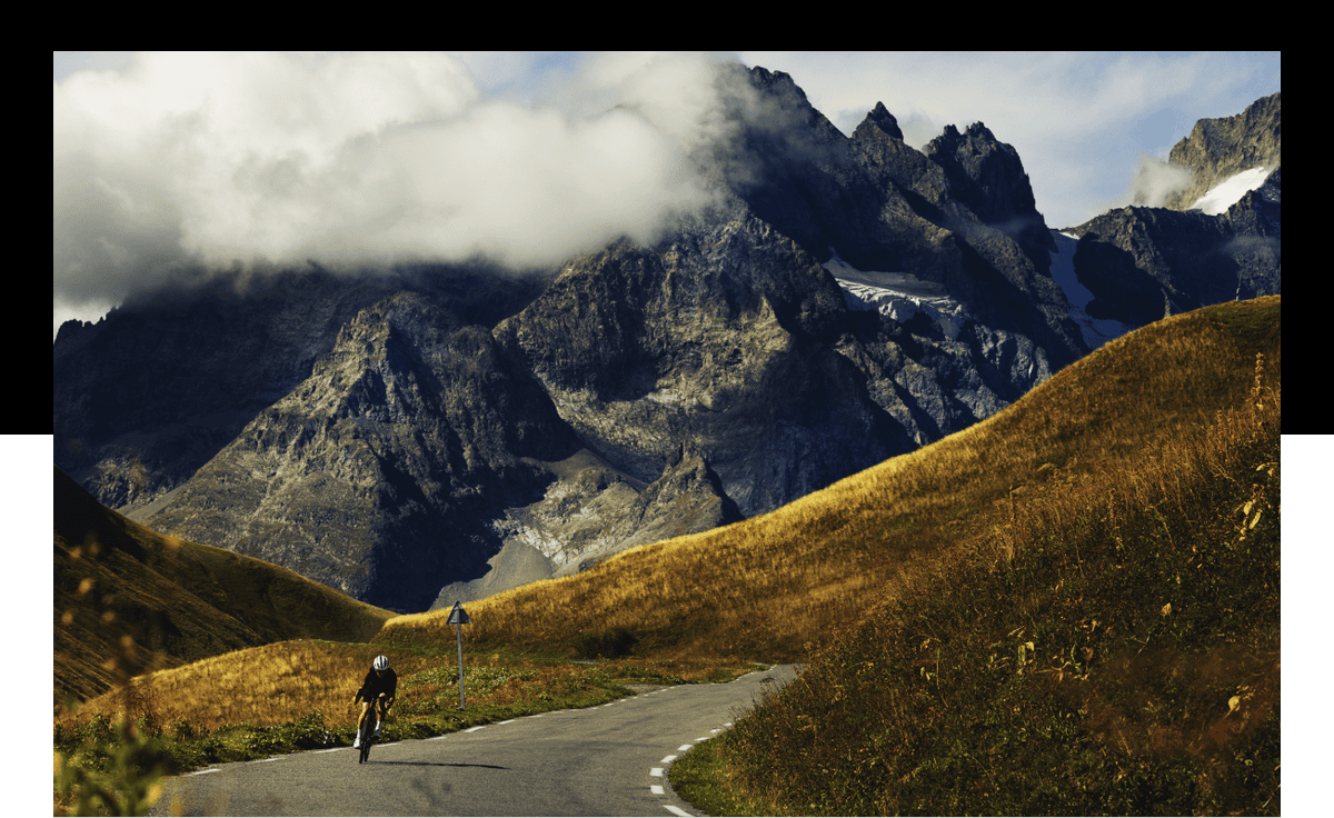 Cyclist riding a Project One bike on a winding mountain road