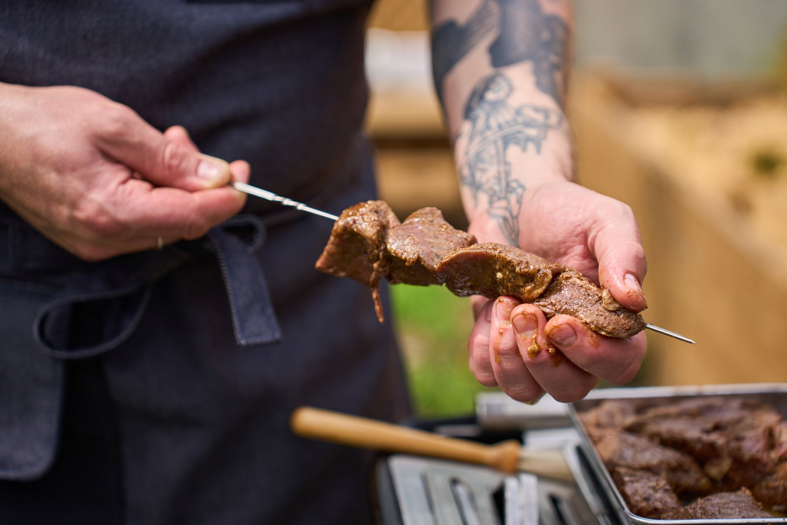 Skewering beef on metal skewer