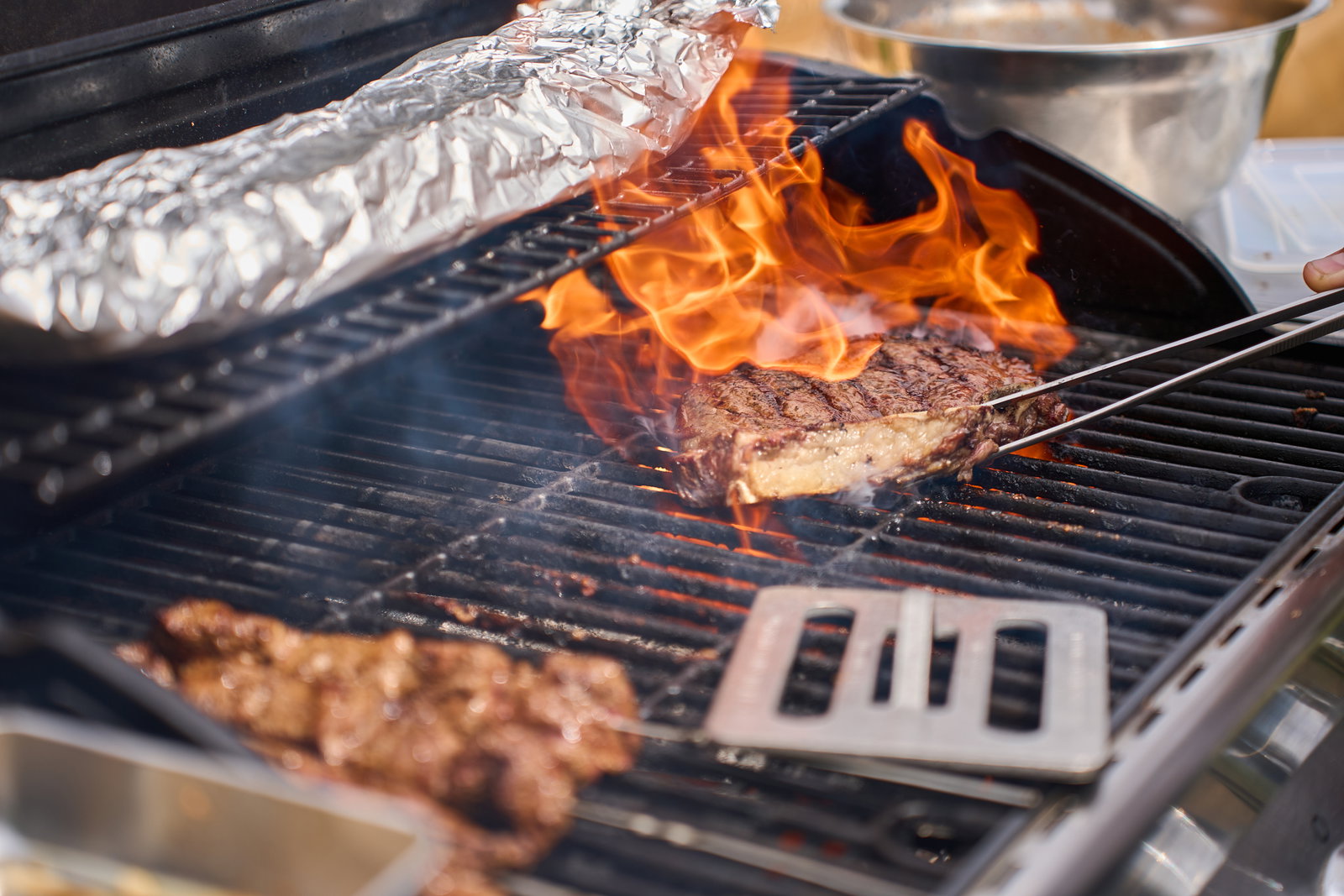 Flipping steak on a grill