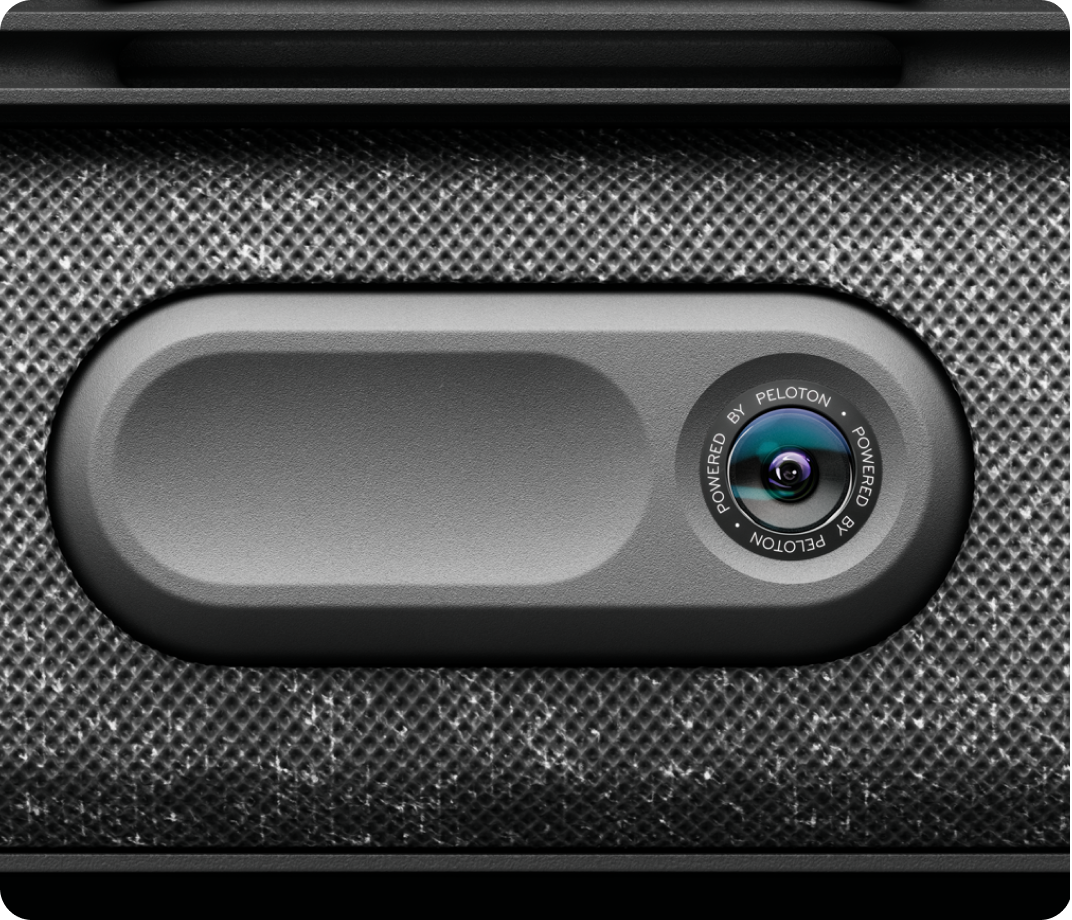 Close-up of the Peloton camera used for real-time movement tracking and form analysis.