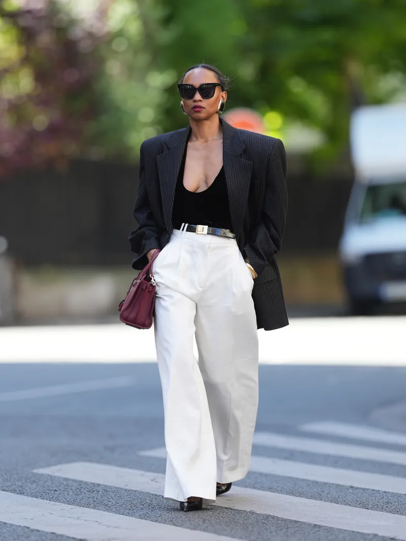 woman walking on street wearing petite dress pants
