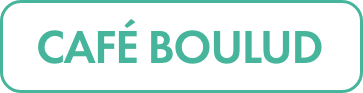 Rectangular white label features the text “CAFE BOULUD” in bold teal capital letters.