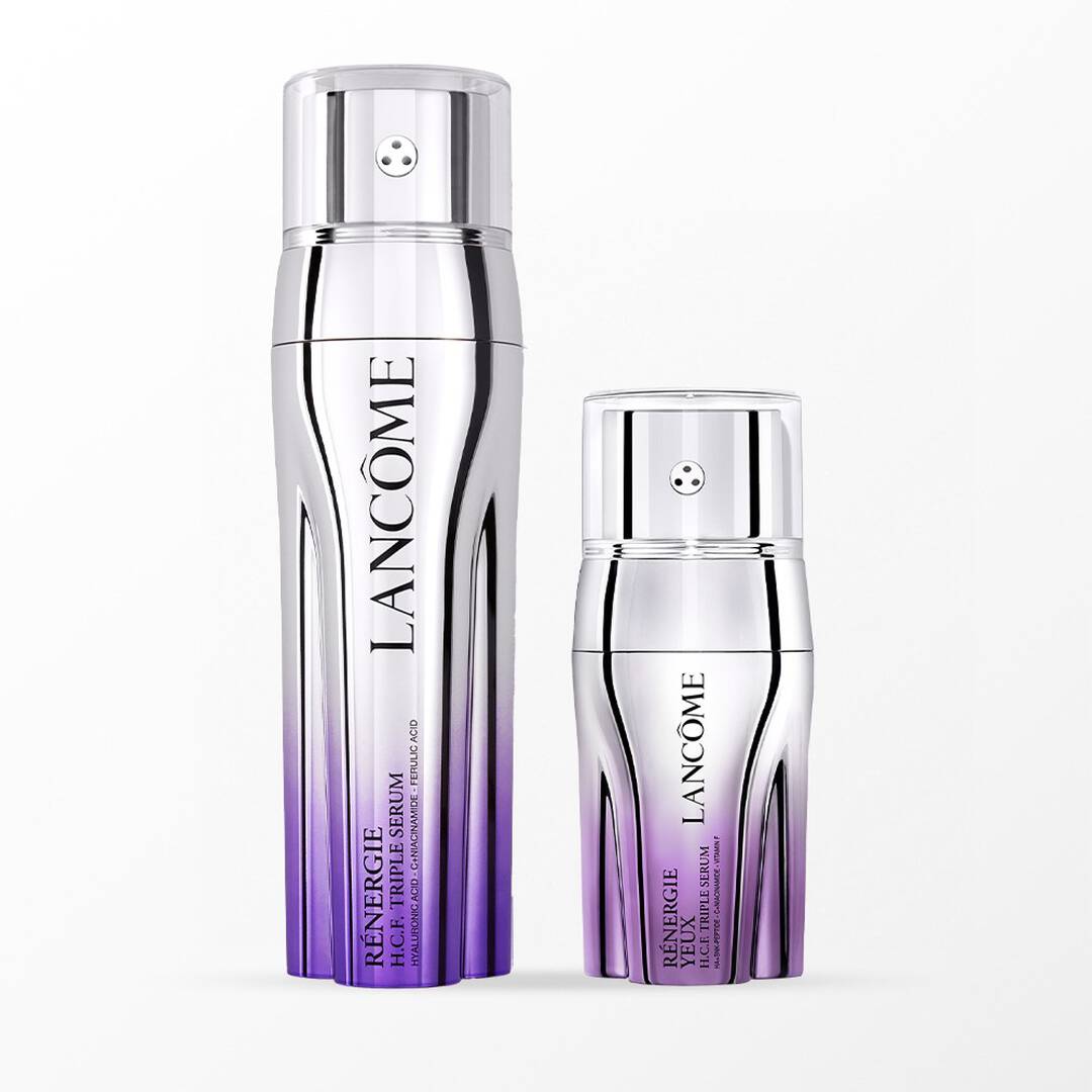 Flaconi metallici Lancôme Rénergie H.C.F. Triple Serum e Rénergie Yeux con sfumature viola su sfondo bianco