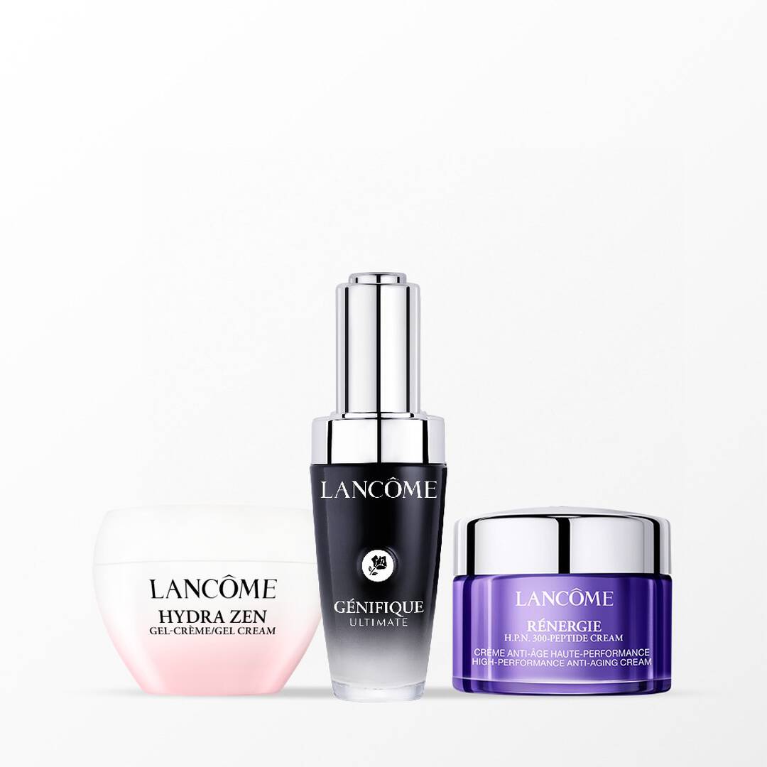 Crema Hydra Zen rosa, siero Génifique Ultimate nero e crema Rénergie viola di Lancôme su sfondo bianco