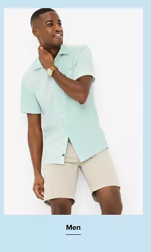 Shop men. Man in button-down shirt and shorts. 