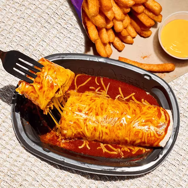 An Enchirito and Nacho Fries on a table. A fork is pulling away part of the Enchirito.