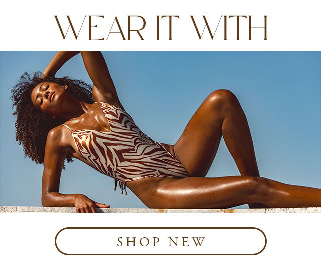 Model laying on her side with a bronze tiger print one piece bikini. Shop new. 