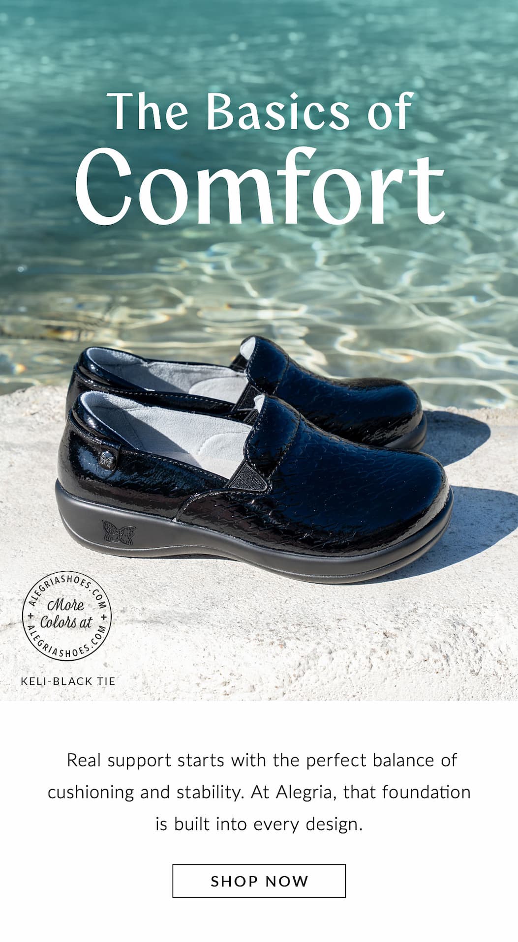 A pair of black, textured patent leather Alegria Keli slip-on shoes rests on a concrete edge with clear turquoise water in the background. Overhead text reads 'The Basics of Comfort' with a button at the bottom labeled 'SHOP NOW'.