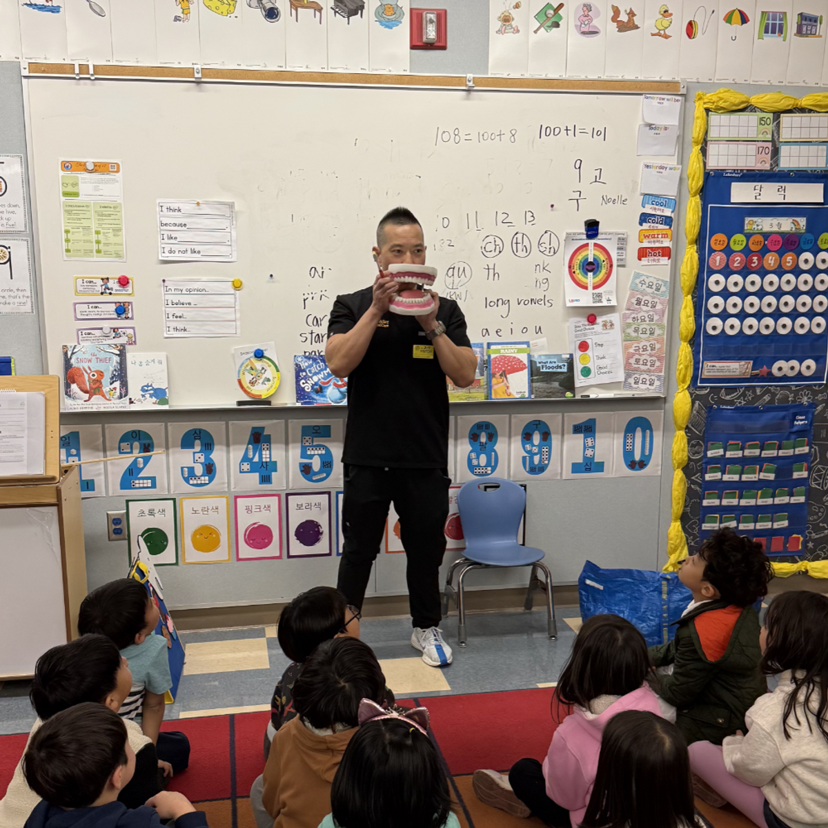 Dr. Casey giving a demonstration of oral health to kids