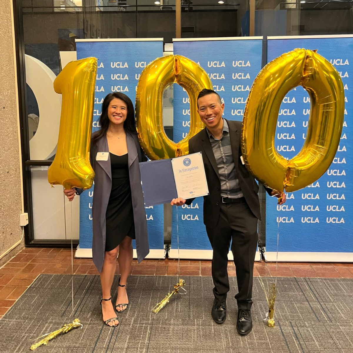 Dr. Casey Lau and Belinda Lau holding balloons