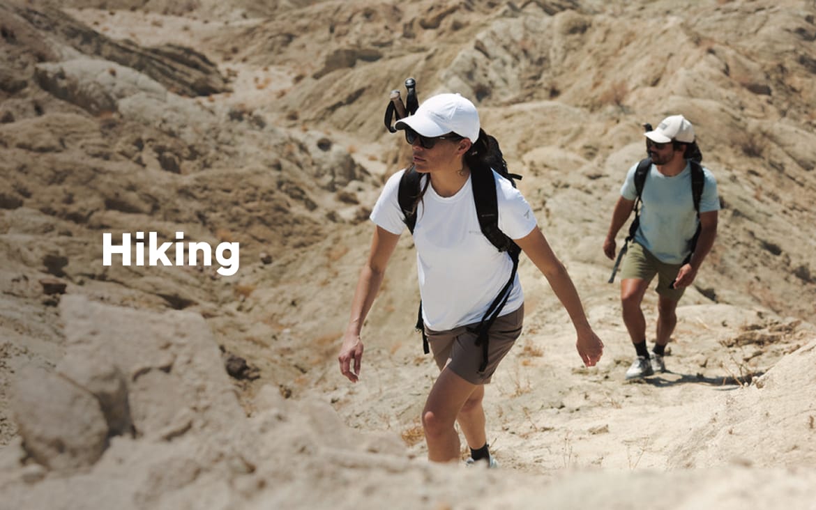 Two hikers walking in a rocky landscape with text: Hiking