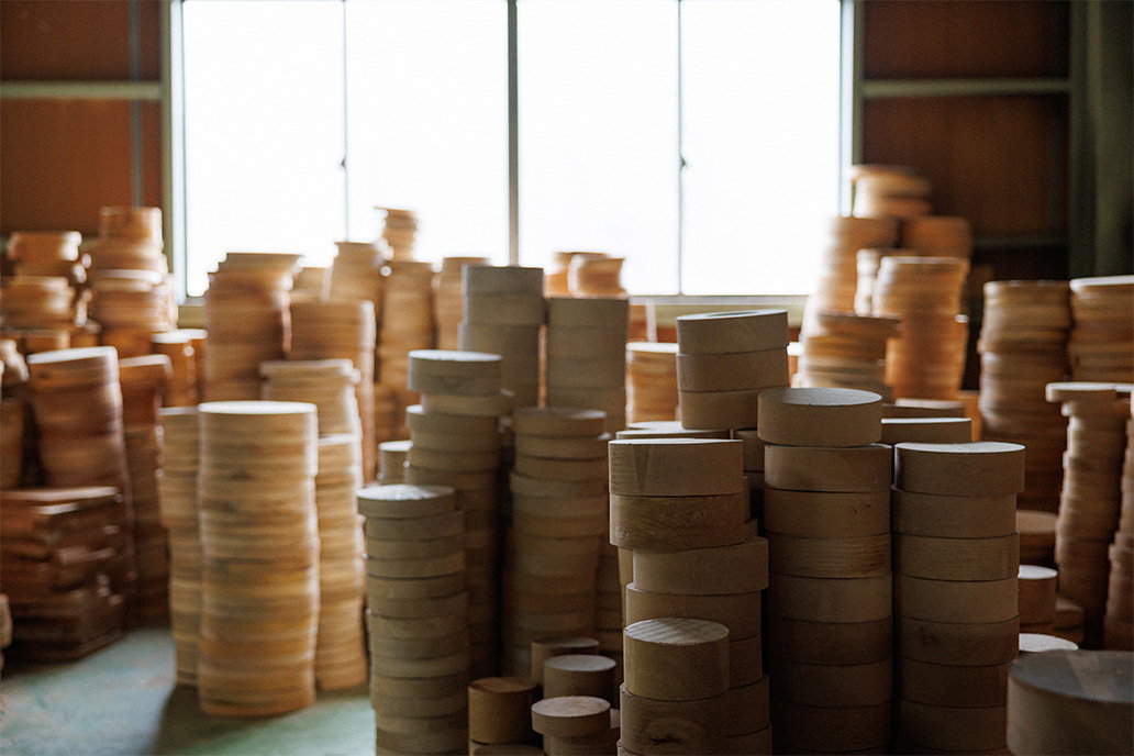 Stacks of wooden box components in the Hata Shikki workshop.
