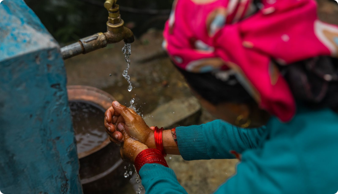 A woman washing her hands.