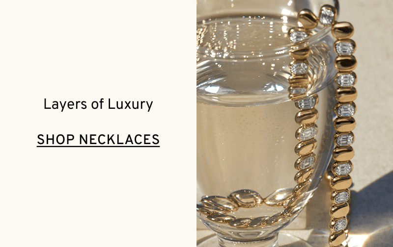 Diamond necklace hanging in water glass. Layers of Luxury. Click to Shop Necklaces