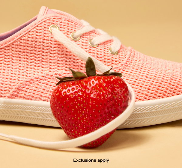 An orange background with a close-up side view of an untied Keds Champion Cotton Mesh Lace-Up in neon coral with a strawberry in the foreground. The email says Juicy Summer Savings. All Styles Now 30% Off. Original Keds Champion Included. Exclusions apply