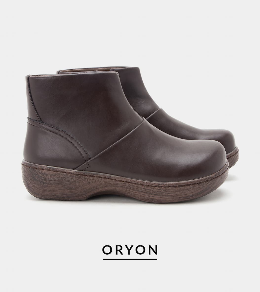 A side profile view of a pair of "Oryon" ankle boots. The boots feature a smooth, dark brown leather upper with subtle seam detailing, an ankle-high shaft, and a thick rocker outsole with a dark wood-grain finish.