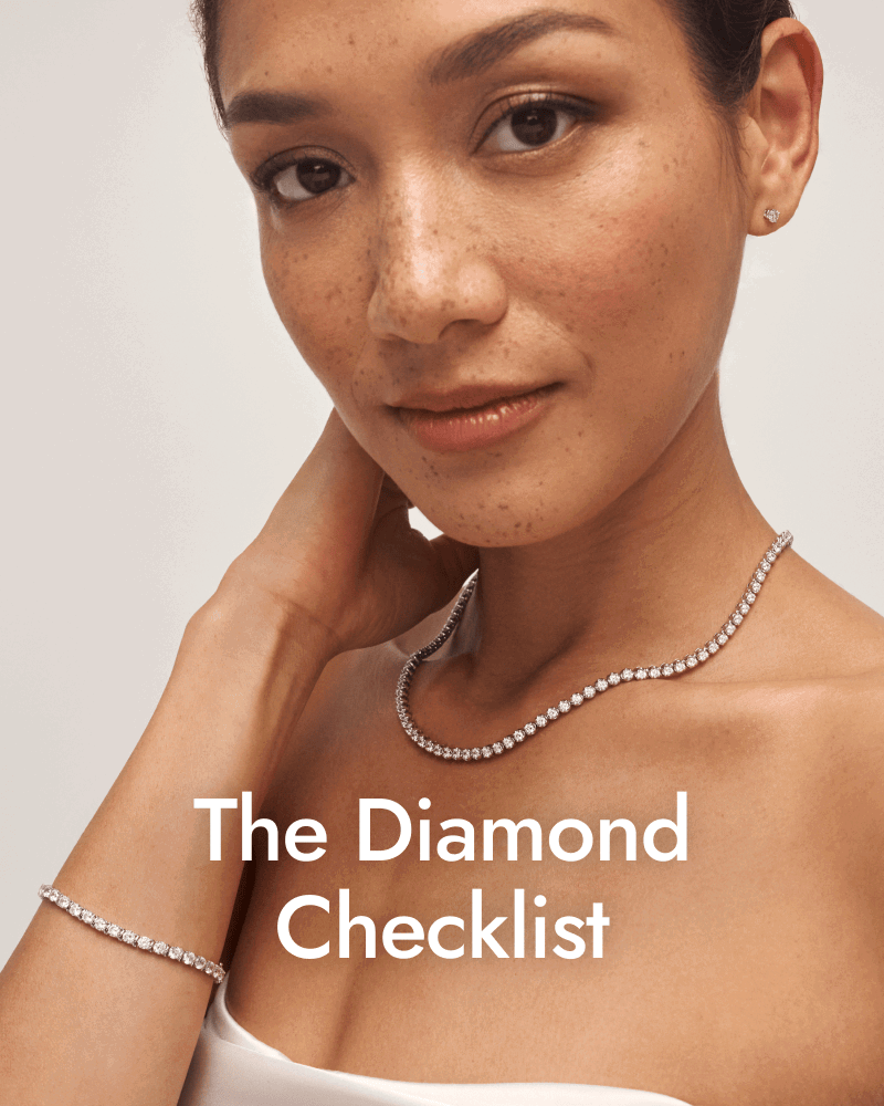 Woman wearing a white gold diamond tennis necklace and bracelet with stud earrings. The diamond checklist.