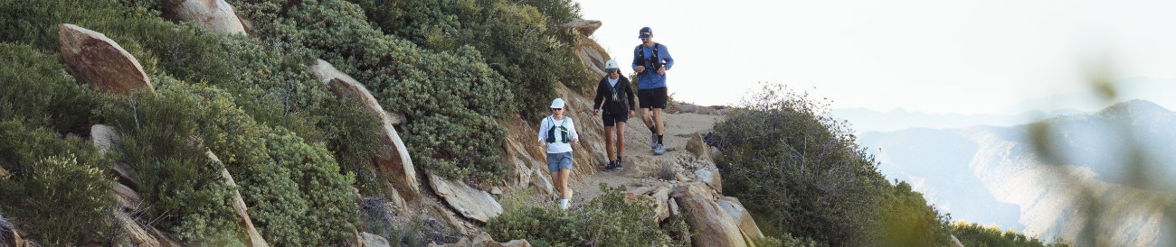 3 trail runners making their way down a path