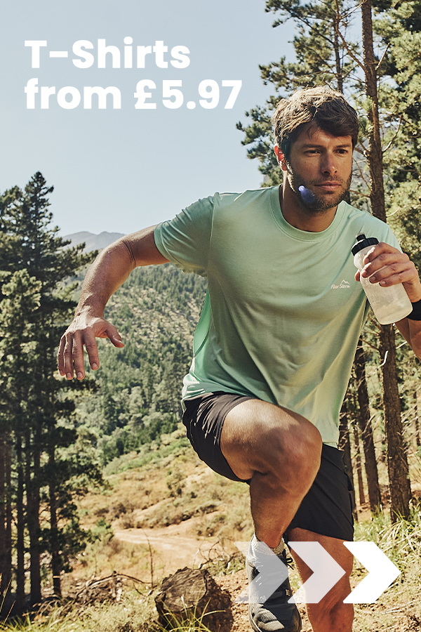 A person runs along a woodland trail wearing a green performance T-shirt, promoting Peter Storm T-shirts from £5.97.