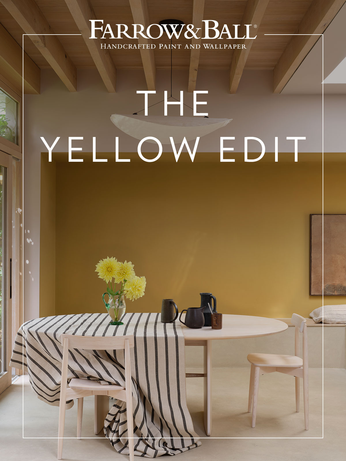 Modern dining area with mustard wall, pale wood furniture, and yellow flowers on the table. The Farrow & Ball logo is positioned at the top of the image.