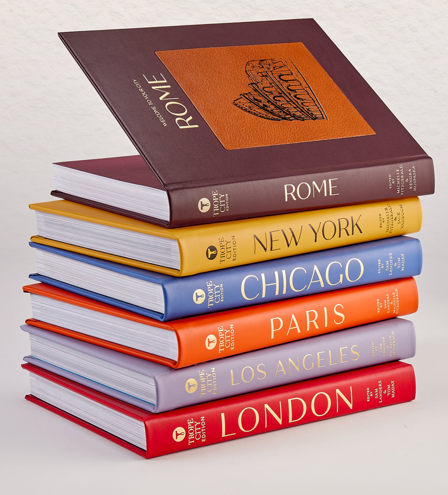 Leather-bound editions of Trope Rome, Trope New York, Trope Chicago, Trope Paris, Trope Los Angeles, and Trope London.
