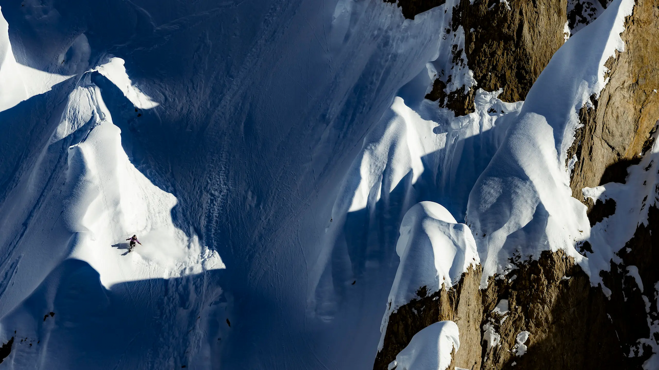 Athlete skiing down face