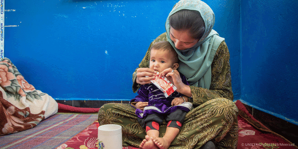 A mother feeding her child. 