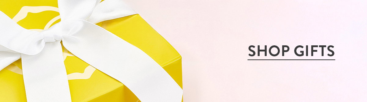 Shop gifts. Yellow gift box with a white ribbon.
