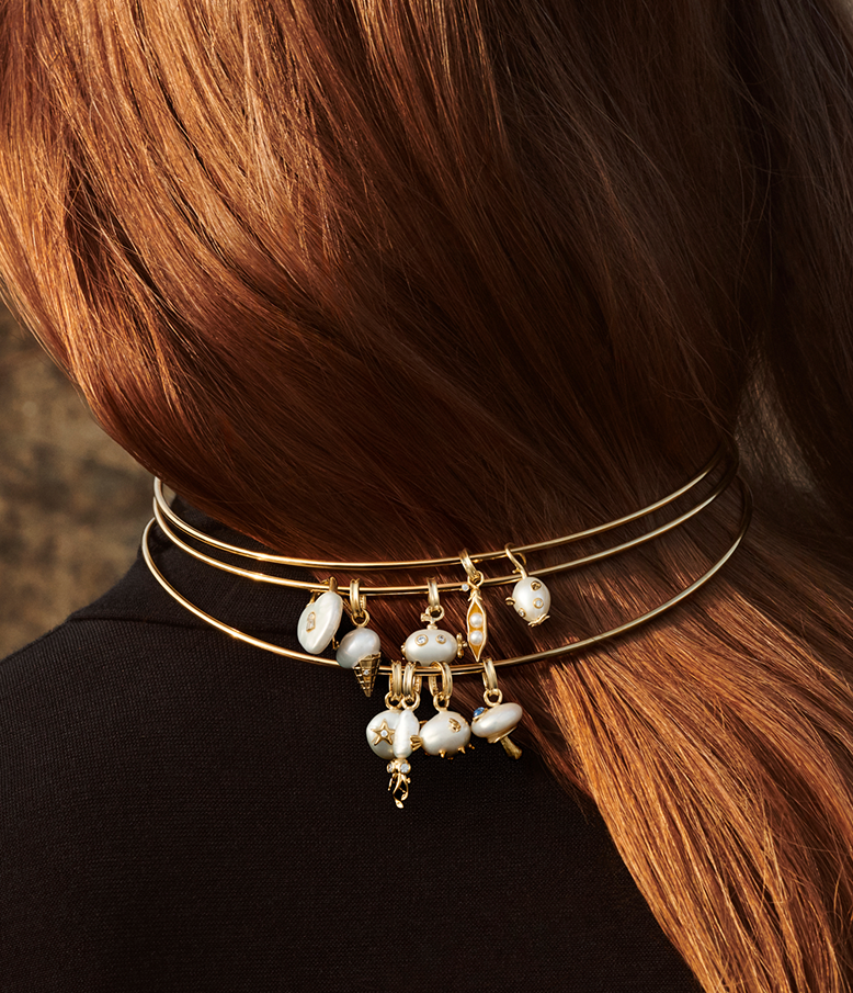 Stack of chokers carrying multiple charms from Pandora Wonders