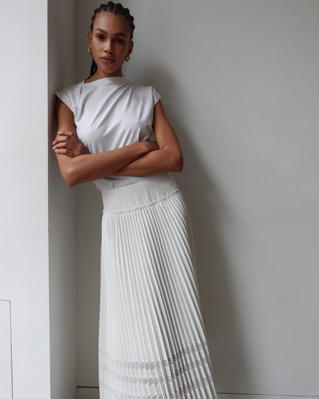 an image of a woman in a white dress holding a purse