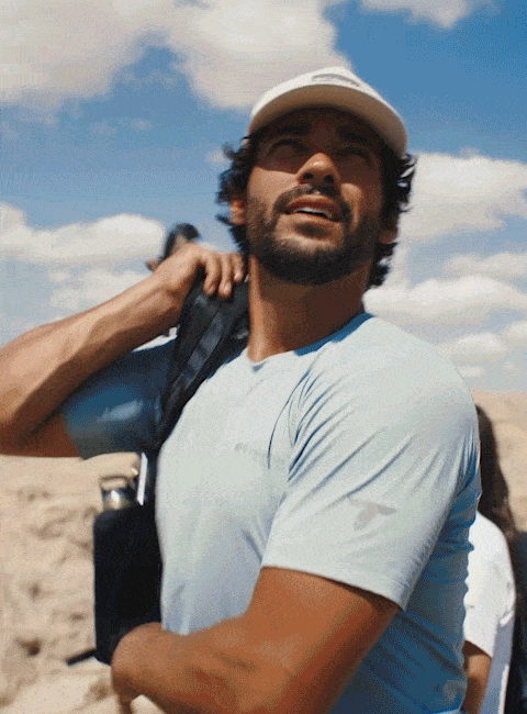 Gif of man and woman hiking and climbing in an arid environment.
